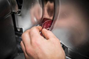 a person is shredding a piece of meat on a machine at Albergo K2 in Madesimo