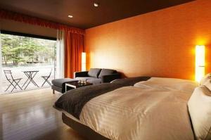 Postel nebo postele na pokoji v ubytování Karuizawa Hotel Longing House