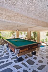 a pool table in a room with a ceiling at Philoxenia Apartments in Karpathos