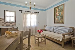 a living room with a couch and a dining room at Philoxenia Apartments in Karpathos
