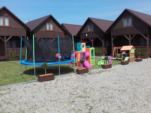 a group of playground equipment in front of a house at Tęczowe Domki in Władysławowo