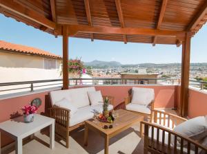 a patio with two chairs and a table on a balcony at RETRO 51 in Rethymno Town