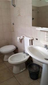 La salle de bains est pourvue de toilettes blanches et d'un lavabo. dans l'établissement Locanda il Cacciatore, à Pari