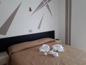 Postel nebo postele na pokoji v ubytování Hotel Santa Caterina