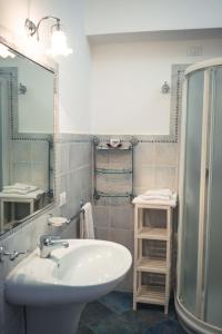 a bathroom with a sink and a mirror at B&B Le Sette Vele Da Riccardo in Santa Marina Salina