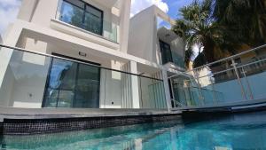 a house with a swimming pool in front of a house at OpenSky Lux in Kallithea Halkidikis