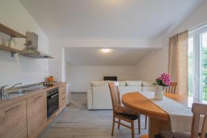a kitchen with a table and a dining room at Middle Istra in Pazin