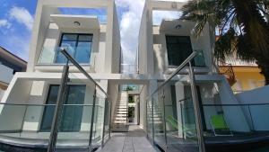 a large white house with glass doors and stairs at OpenSky Lux in Kallithea Halkidikis