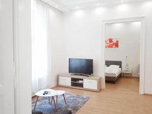 ブダペストにあるAkacfa 36 Budapest 91 mt 3 bedroom District 7のリビングルーム(薄型テレビ、テーブル付)