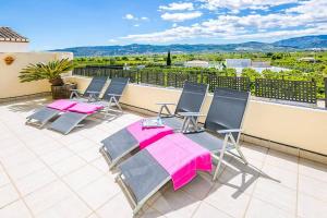 a patio with a table and chairs on a balcony at Fully Airconditioned Costa Blanca Pool House with Superb Views Over the Orba Valley, Sleeps 12 in Benimeli