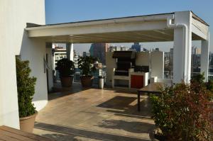 awning on the roof of a building with plants at Apart Lyon Suite in Santiago