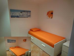 a bedroom with a bed with an orange mattress at Bungalow Villa Sun in Playa Paraiso