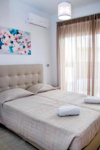 a bedroom with a large bed with two pillows on it at Gennadi Gardens exclusive apartments in Gennadi +25 photos