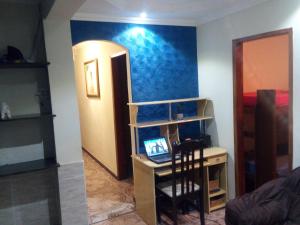 a room with a desk with a laptop on it at Pousada Expominas in Belo Horizonte