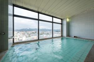 a swimming pool with a view of a city at Annex Royal Hotel in Odate