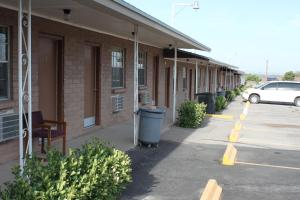 an empty parking lot next to a building with a trash can at Deluxe Inn Motel in Sparks