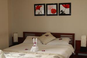 a bed with a stuffed bunny sitting on top of it at Long Life Riverside Hotel in Hoi An