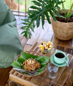 una mesa con un plato de comida y una taza de café en Bamboo & B en Licin