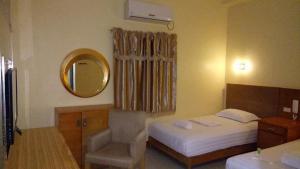 Tempat tidur dalam kamar di Jeamco Royal Hotel-Cotabato