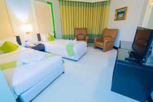 Postel nebo postele na pokoji v ubytování Asawann Hotel Nongkhai