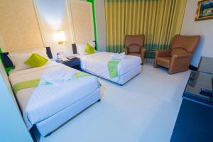 Postel nebo postele na pokoji v ubytování Asawann Hotel Nongkhai