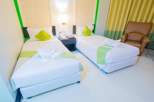 Postel nebo postele na pokoji v ubytování Asawann Hotel Nongkhai
