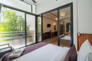 Voodi või voodid majutusasutuse The Tito Suite Residence toas