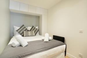 a bedroom with a large bed with pillows on it at Rent a Room - Chenier Paradise in Paris
