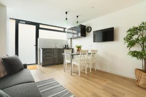 a living room with a table and a kitchen at Rent a Room - Chenier Paradise in Paris