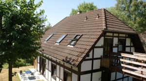 a house with a tiled roof with a porch at Willingen, zeit für Dich in Frankenau