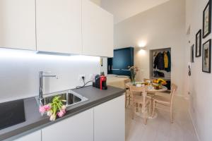 a kitchen with a sink and a dining room at casa minù lamarmora in Cagliari