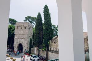 a view of a building with trees and a white car at Ravello In in Ravello