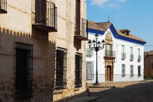 a building with a street light in front of it at El Ventanal de Almagro in Almagro