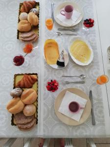 une table recouverte de différents types de pain et de fromage dans l'établissement B&B Chantery, à Coxyde