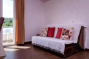 a bedroom with a bed with pillows and a window at Apartments Marković in Stari Grad