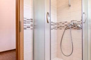 a shower with a shower head in a bathroom at Apartments Marković in Stari Grad