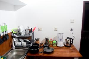 a kitchen counter with a sink and a counter top with a counter top at My Place Hikkaduwa in Hikkaduwa