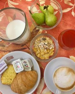 a table with a plate of bread and a bowl of milk at Albergo Le Sorgenti in Chianciano Terme