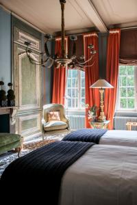 a bedroom with a large bed and a chair at B&B The Verhaegen in Ghent +98 photos