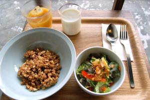 
a bowl of food on a wooden table at Kinco. hostel+cafe Takamatsu, Setouchi in Takamatsu
