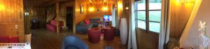 a view of a living room with a couch and a television at La Clusaz Ski aux pieds in La Clusaz