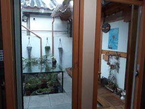 a glass door leading into a room with plants at Hanok Guesthouse Nuha in Seoul