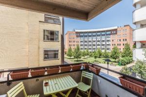 a balcony with chairs and a table and a building at Dossetti, Bologna by Short Holidays in Bologna