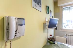 a hospital room with a phone on the wall at Dossetti, Bologna by Short Holidays in Bologna