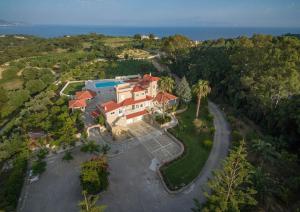 an aerial view of a house on a hill next to the ocean at Hidden Gem Estate - Superior luxury villa large private pool stunning sea & mountain views 5 acres of lush gardens World class accommodation in Spartia