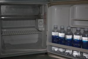 an open refrigerator with bottles of water in it at Thinh Thien Motel in Vĩnh Hy