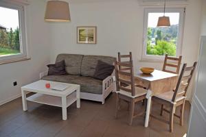 a living room with a couch and a table at Ferienhaus in Goehren in Göhren