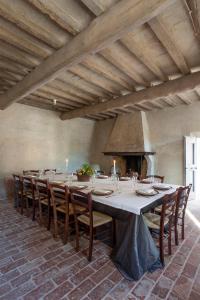 una lunga sala da pranzo con un lungo tavolo e sedie di Corte Mainolda a Castellucchio