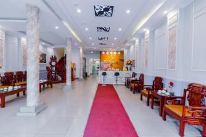 a corridor with chairs and a red carpet at A25 Hotel - 185 Lò Đúc in Hanoi