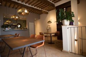 a room with a table, chairs, and a refrigerator at Podere Montale Il Borgo in Seggiano